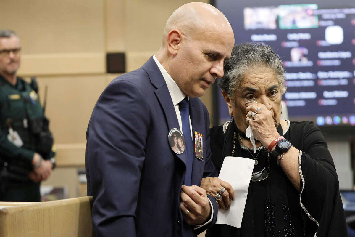 Frank Urrutia escorts his mother, Martita Urrutia, back to her seat after she gave an impact statement on Friday, July 24, 2026.