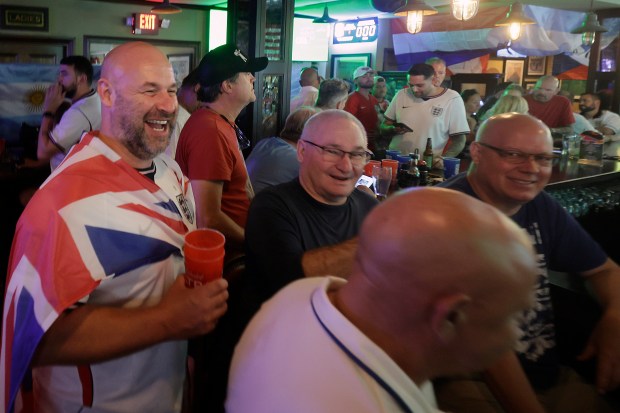 Tom Wilson is draped in a flag as he joins other England fans as they gather to watch the game at Waxy's Irish Pub in Fort Lauderdale on Saturday, July 11, 2026. (Mike Stocker/South Florida Sun Sentinel)