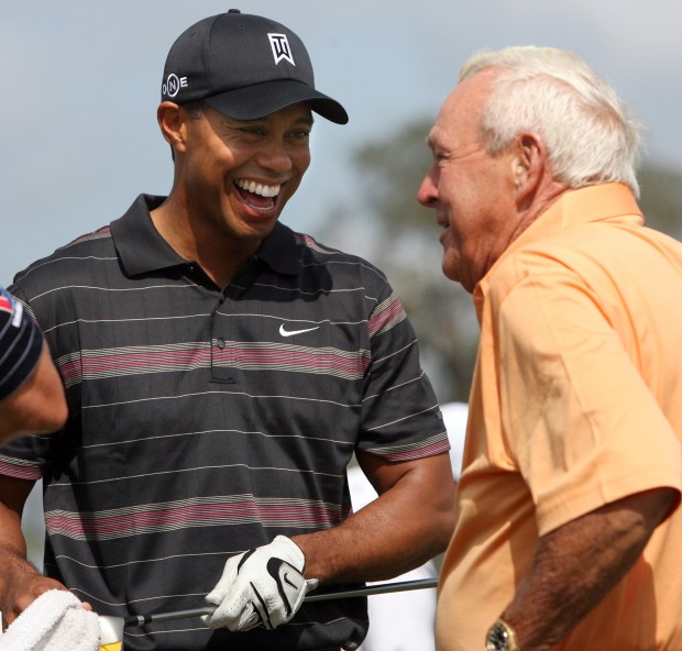 Tiger Woods (left) and Arnold Palmer share a laugh together on the practice range during the third round of the Arnold Palmer Invitational March 15, 2008 at the Bay Hill Club and Lodge in Orlando. (Gary W. Green/Orlando Sentinel/MCT)