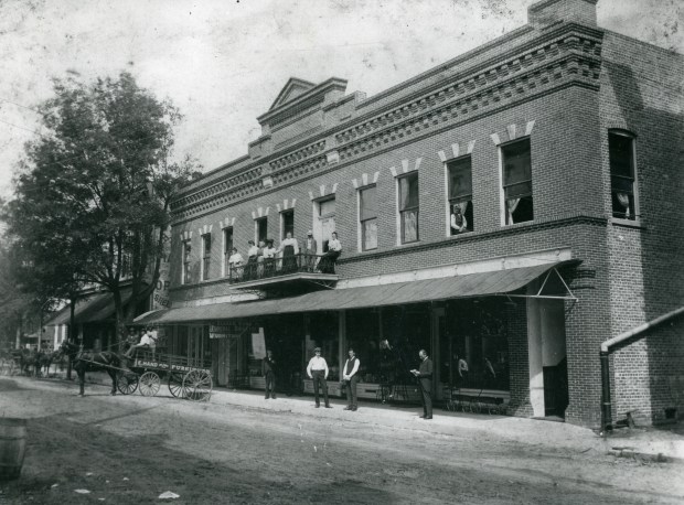 The Elijah Hand building is the oldest remaining structure downtown. Hanging under the awning in this late-1800s to early 1900s photo is a wooden sign that reads "Elijah Hand, Funeral Director". The building is now the home of Allure Restaurant and Lounge. (Orange County Regional History Center)