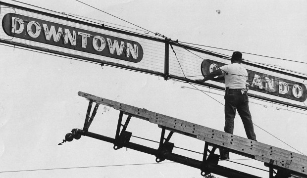 The bright lights: A neon sign at Colonial Drive and Orange Avenue welcomes visitors to downtown Orlando in 1967. By then, the popularity of shopping centers was drawing suburban shoppers away from the urban core. (Orlando Sentinel file)