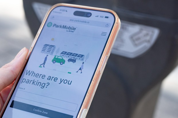 Orlando Health visitor uses ParkMobile system to pay for parking on West Copeland Drive in Orlando, FL, Thursday, July 16, 2026. (Barrett Walsh/Orlando Sentinel)