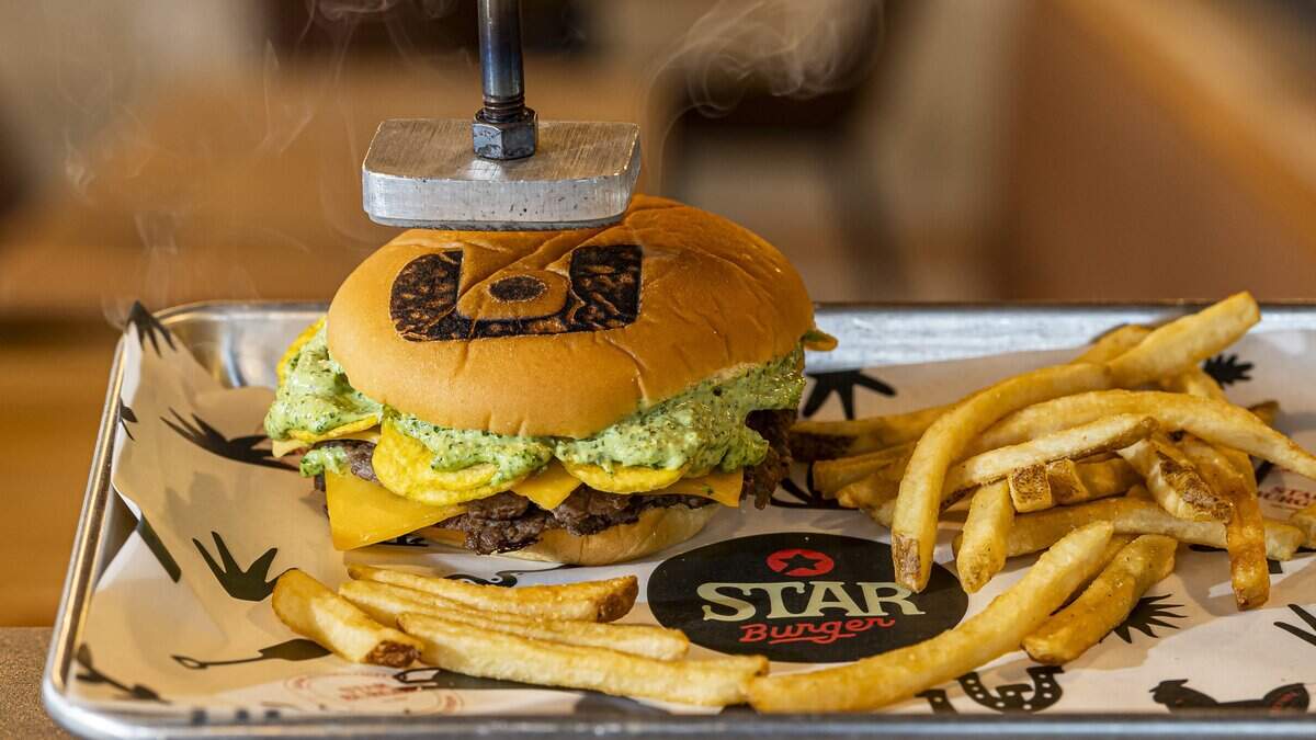 The Canes Burger gets a stamp of the “U” on the bun at Star Burger in Miami.