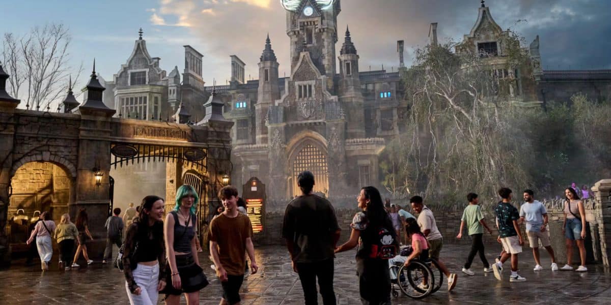 epic universe guests walk around dark universe with castle in background