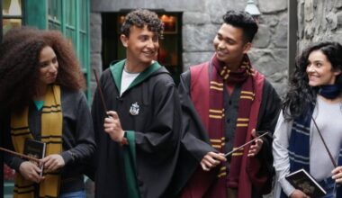 Harry Potter fans in robes with wands in Universal's Diagon Alley