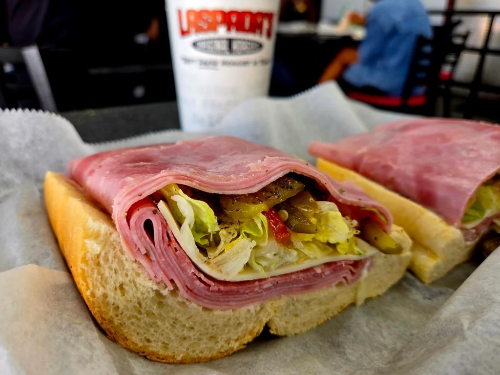 an open face deli sandwich with deli meats and toppings