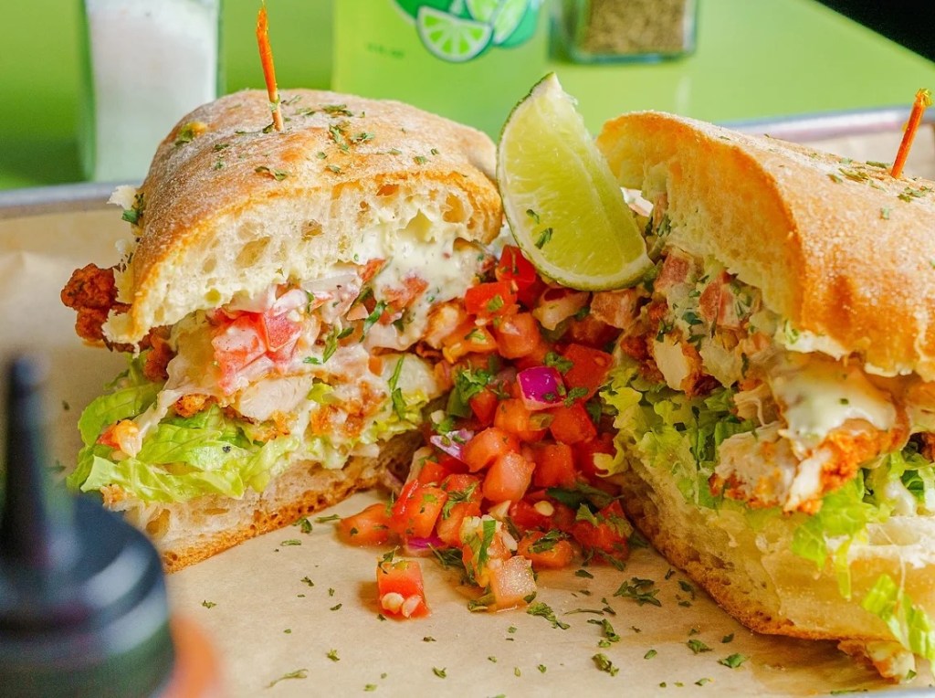 a sandwich loaded with tomatoes and veggies