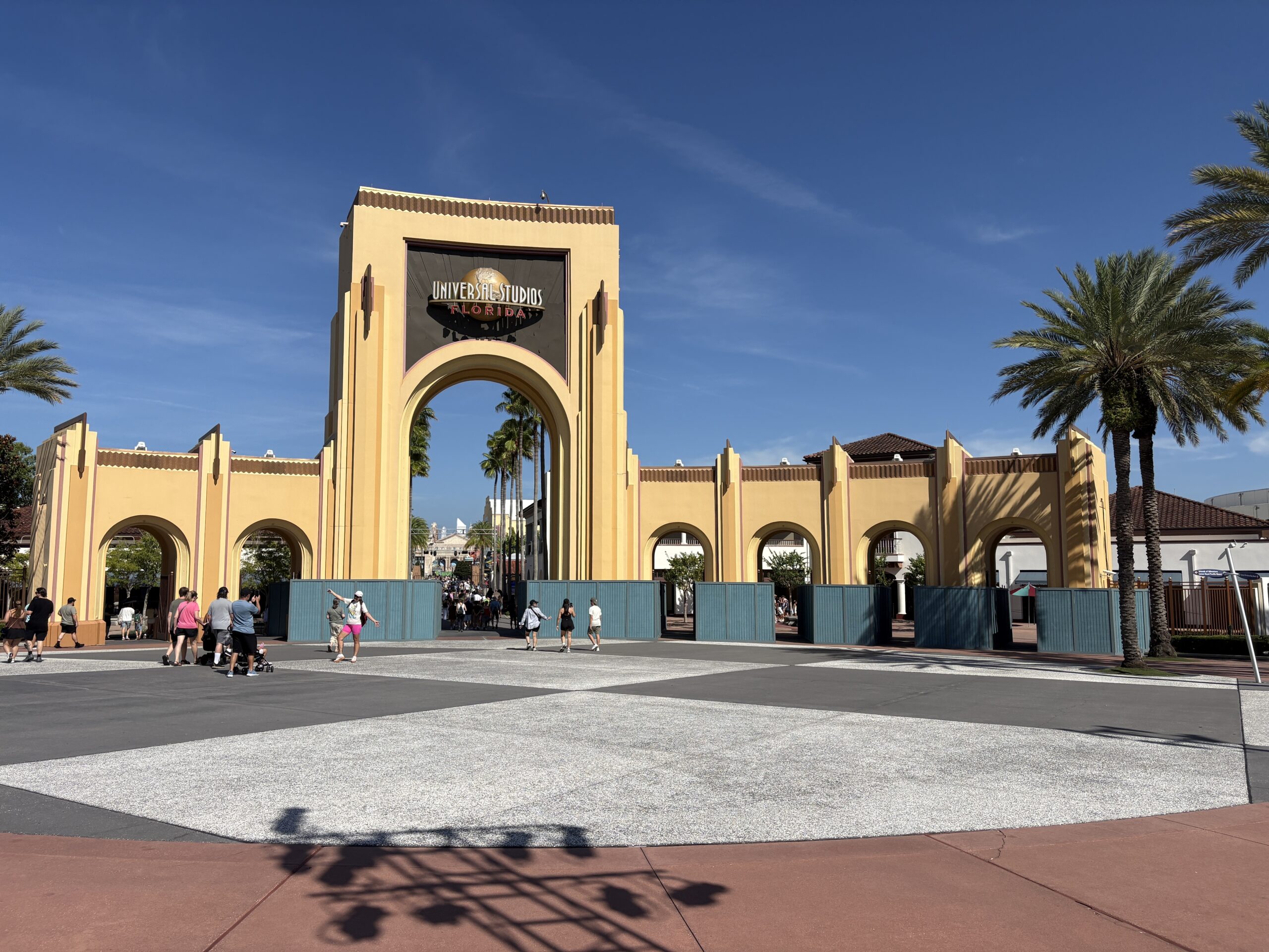 The construction walls we first spotted last week at the iconic archway have expanded at the front of Universal Studios Florida. While last week they comprised the first two entry points on the right side, they are now throughout except for the far left side.
