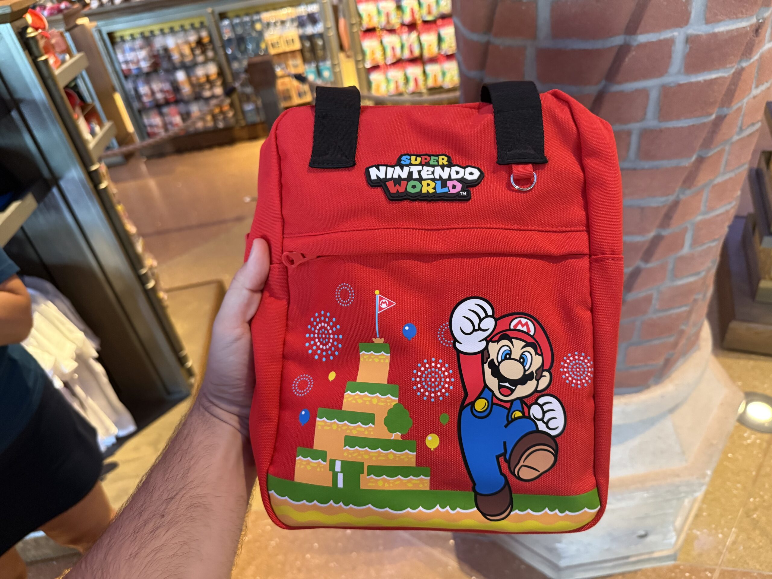 This red backpack comes with two black straps and features Mario and Mount Beanpole on the front zippered pocket.