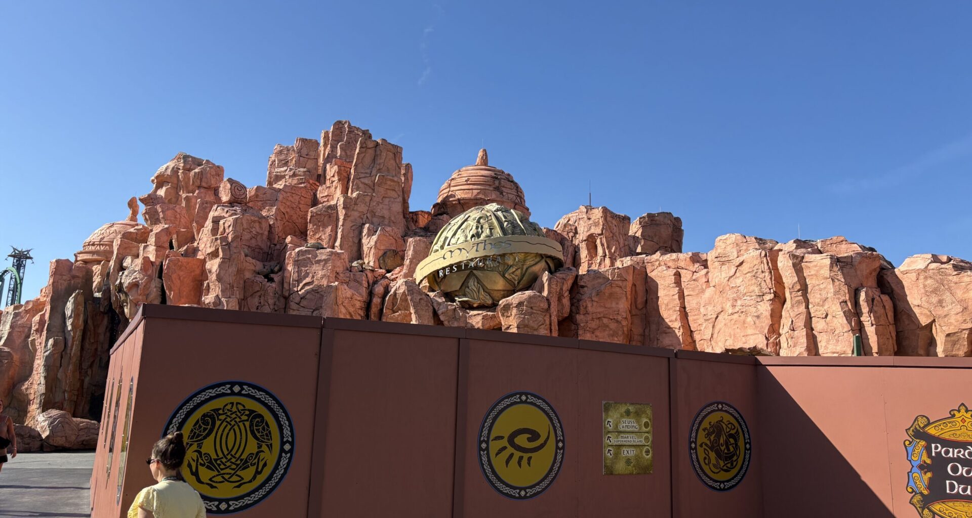 We noticed walls go up outside Mythos Restaurant last week, and since then it appears tree removal has begun in the area. While there are still several trees behind the walls, there were noticeably fewer trees than there were a week ago.