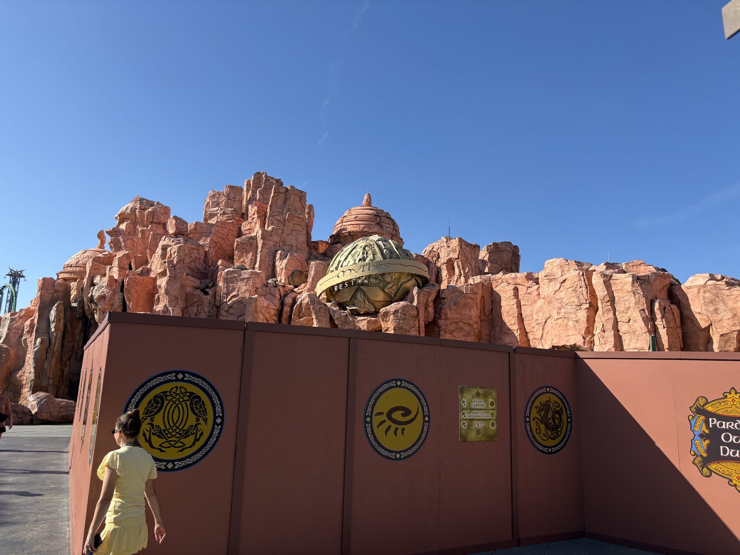 We noticed walls go up outside Mythos Restaurant last week, and since then it appears tree removal has begun in the area. While there are still several trees behind the walls, there were noticeably fewer trees than there were a week ago.