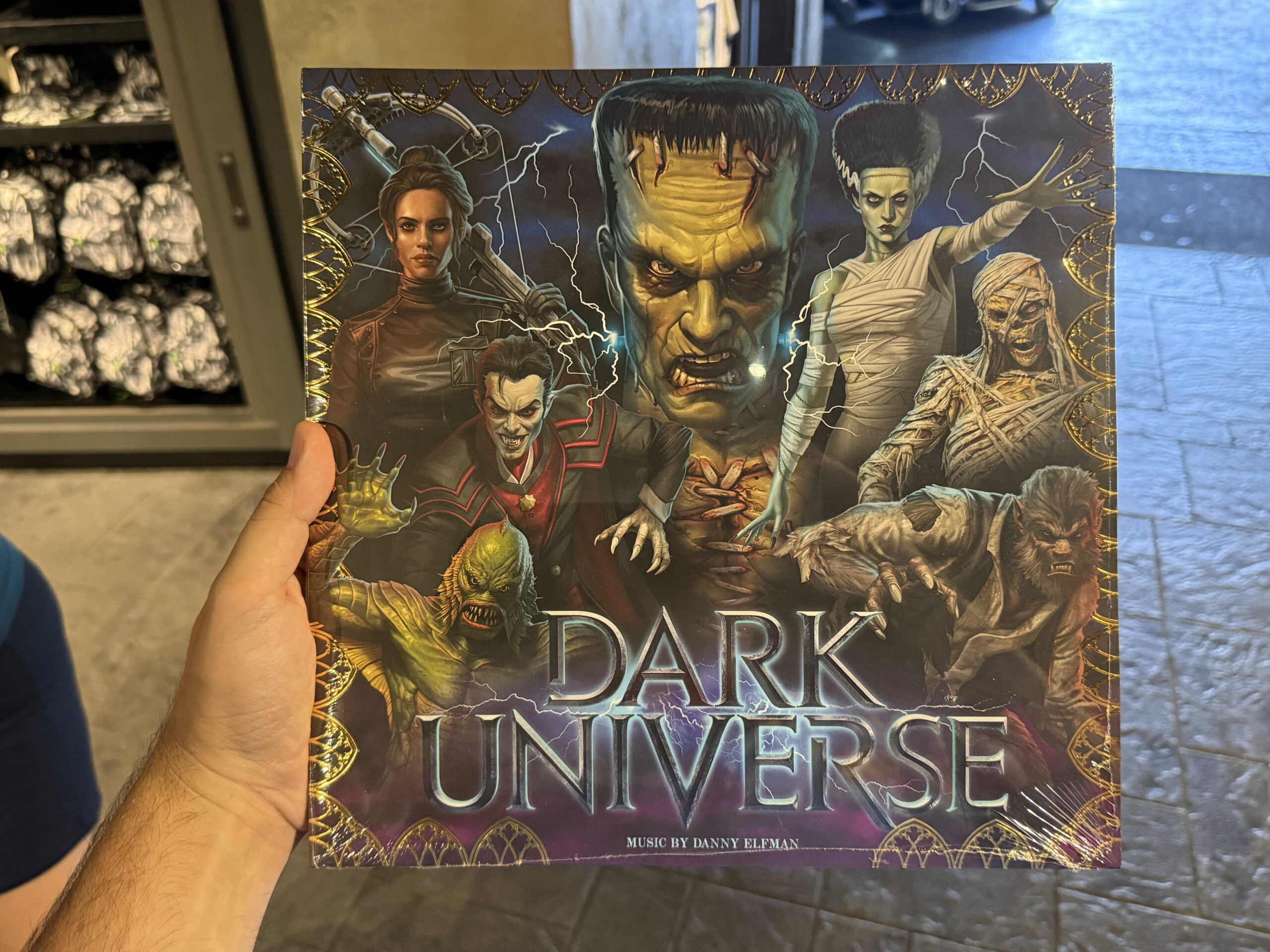 This is a new edition of the Dark Universe vinyl record featuring music by Danny Elfman. The updated cover has a gold foil border design.