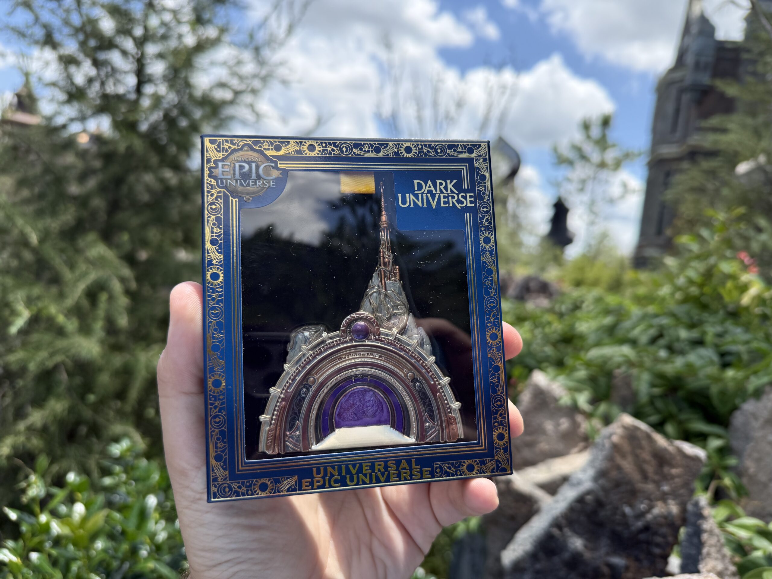 Another new pin is part of a series of portal-inspired pins being released quarterly this year. It's a detailed depiction of the Dark Universe portal with a purple smoky center.