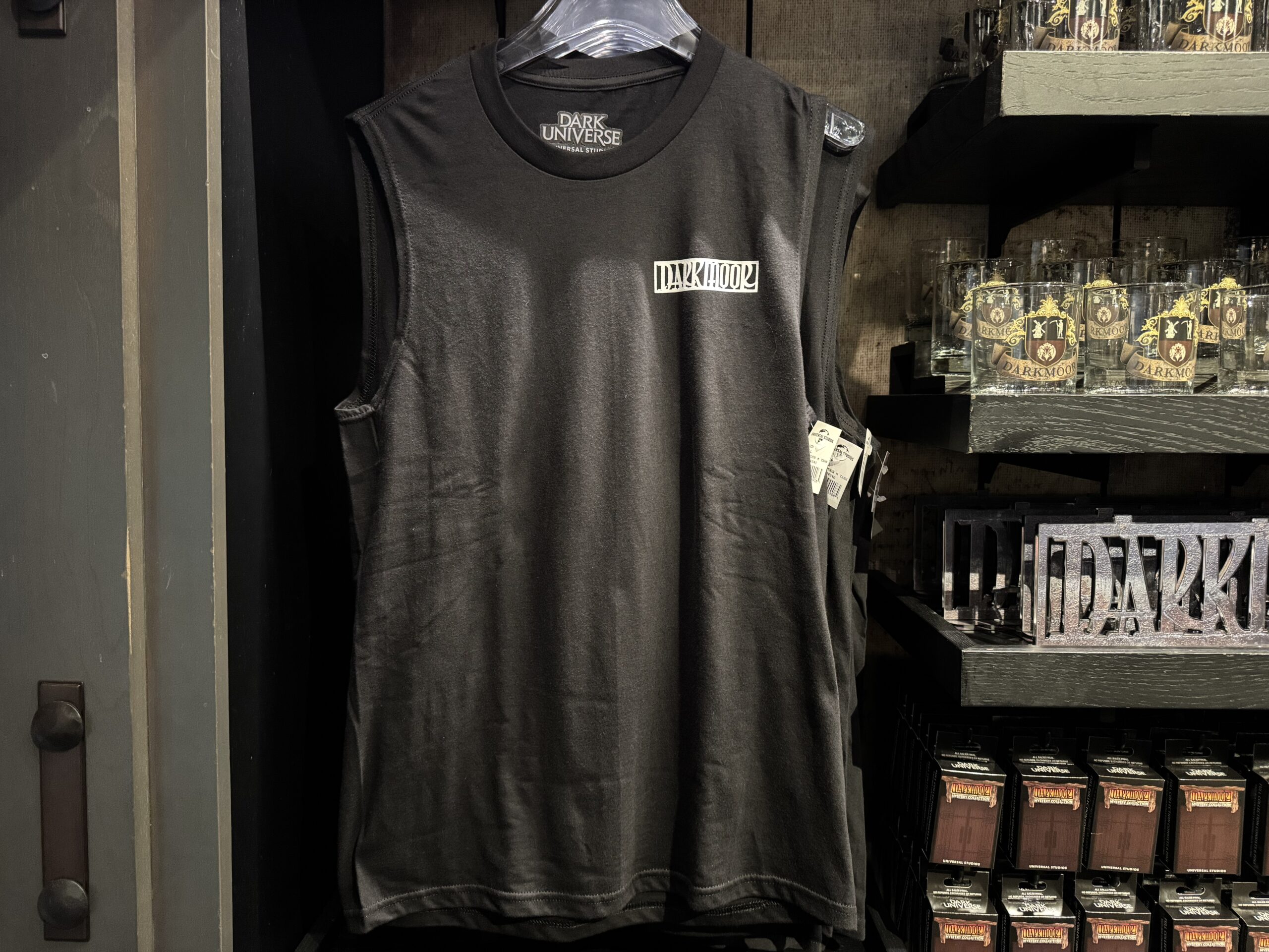 The reminder is also in white on the back of this black tank. The Darkmoor wordmark is on the left chest.