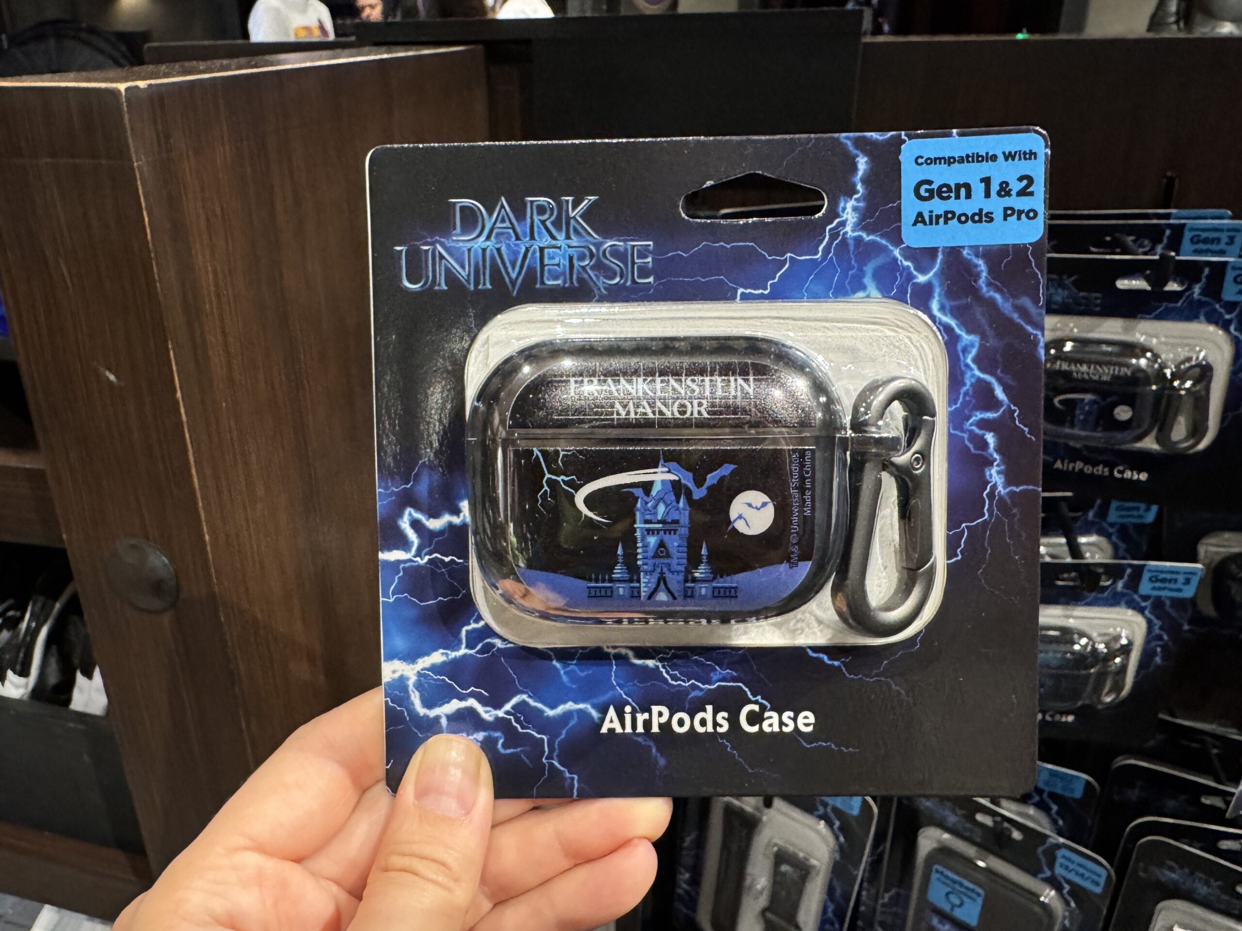 There are multiple versions of the AirPods case for Gen 1 and 2 AirPods Pro and Gen 4 AirPods. All three styles feature the towers of Frankenstein Manor in blue with bats flying across the sky and moon.