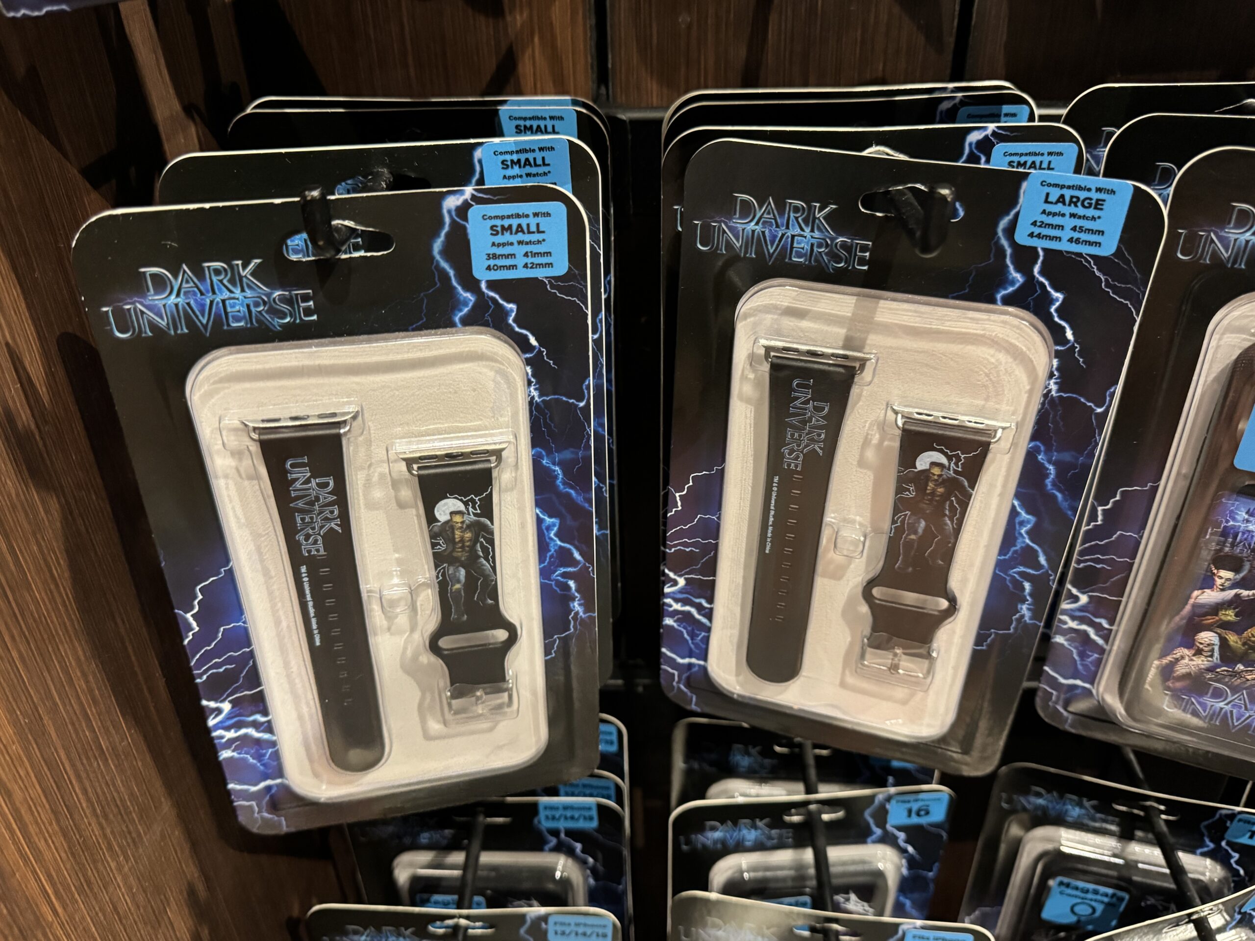 This watch band is black. The dotted end has the Dark Universe wordmark. The Monster is pictured on the other side with lightning and a full moon behind him. there are sizes compatible with small and large Apple Watches.
