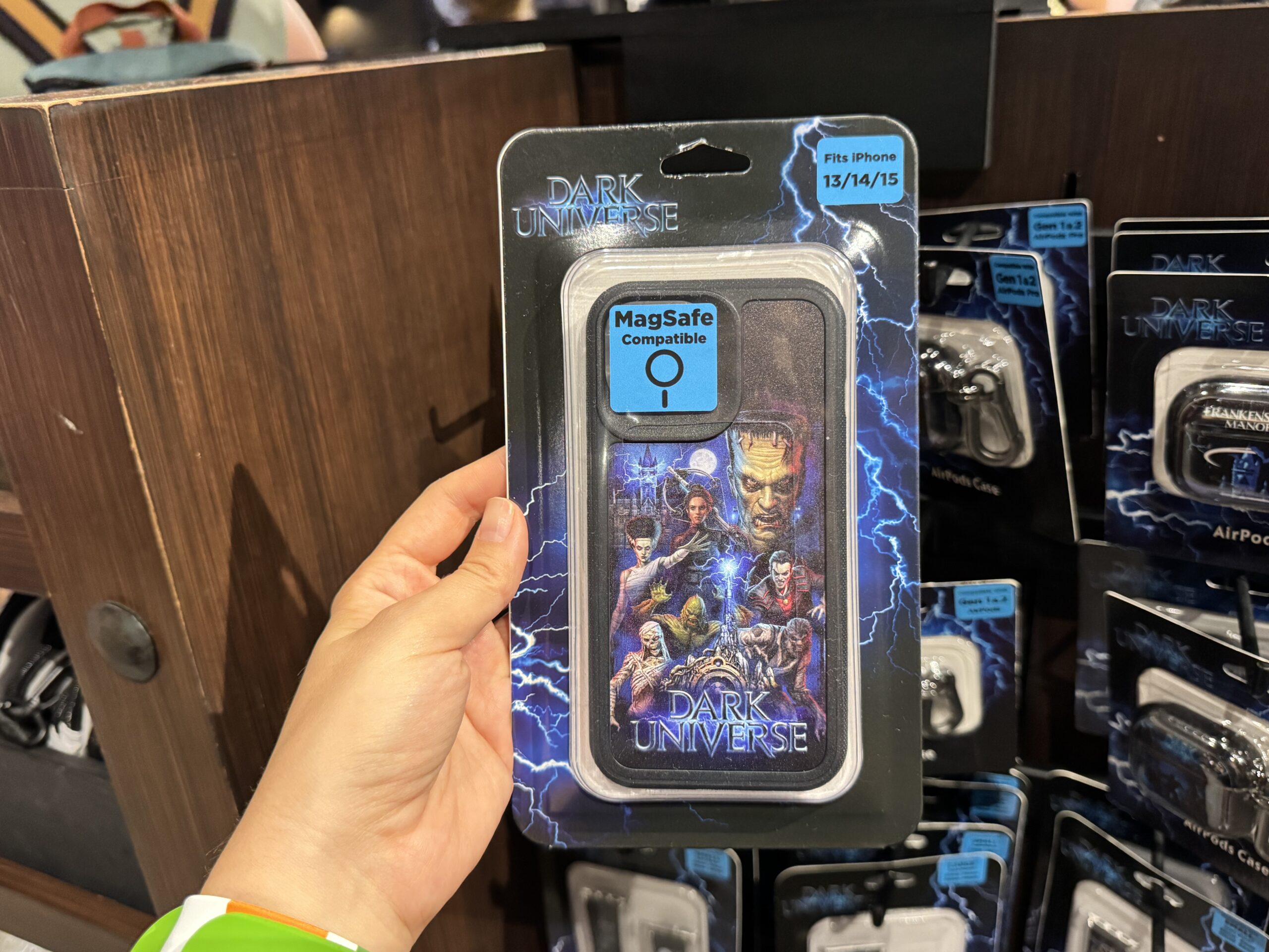 This phone case has a vibrant design with multiple monsters and Victoria Frankenstein. In the background is Frankenstein Manor. The land's portal and wordmark are at the bottom.