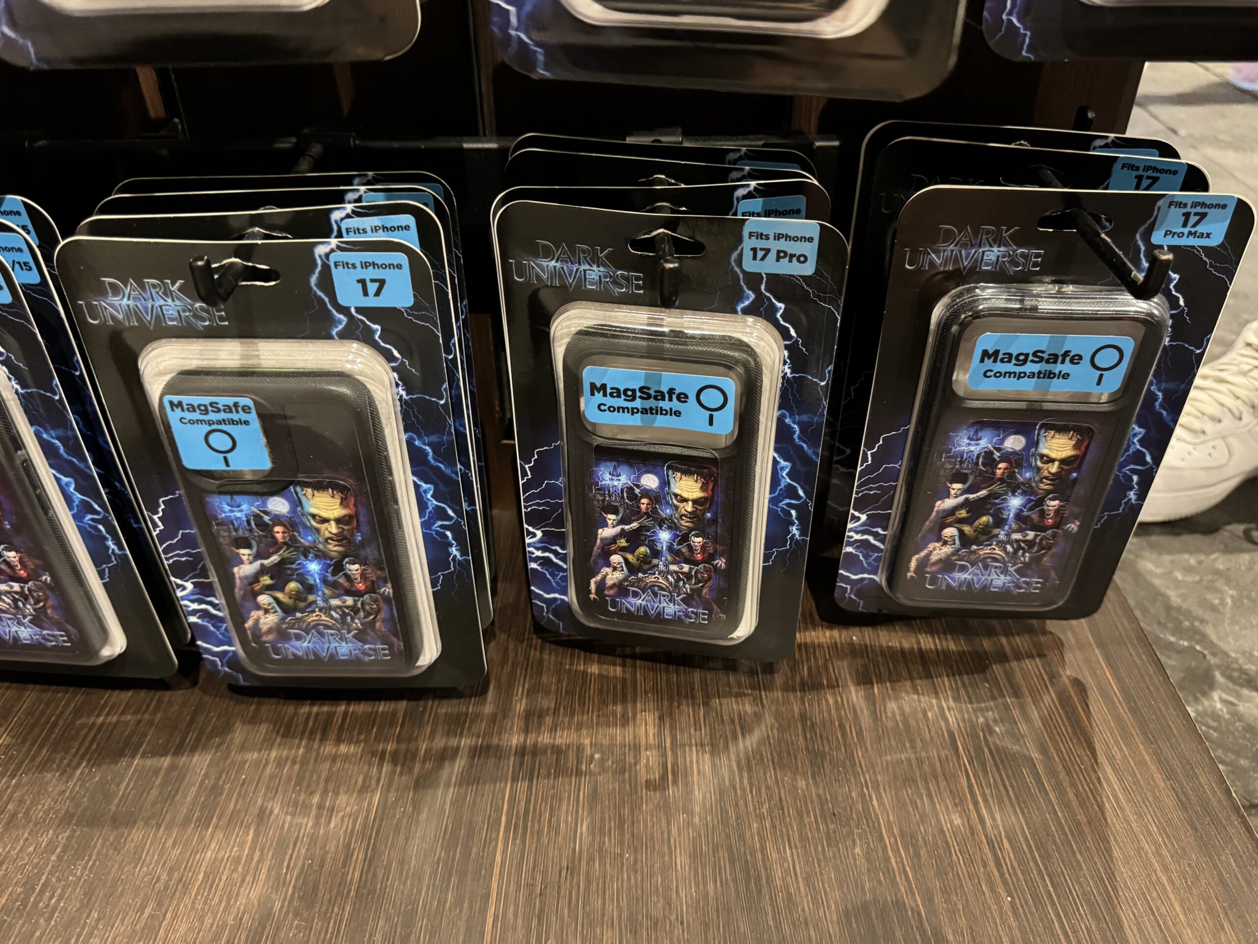 This phone case has a vibrant design with multiple monsters and Victoria Frankenstein. In the background is Frankenstein Manor. The land's portal and wordmark are at the bottom.