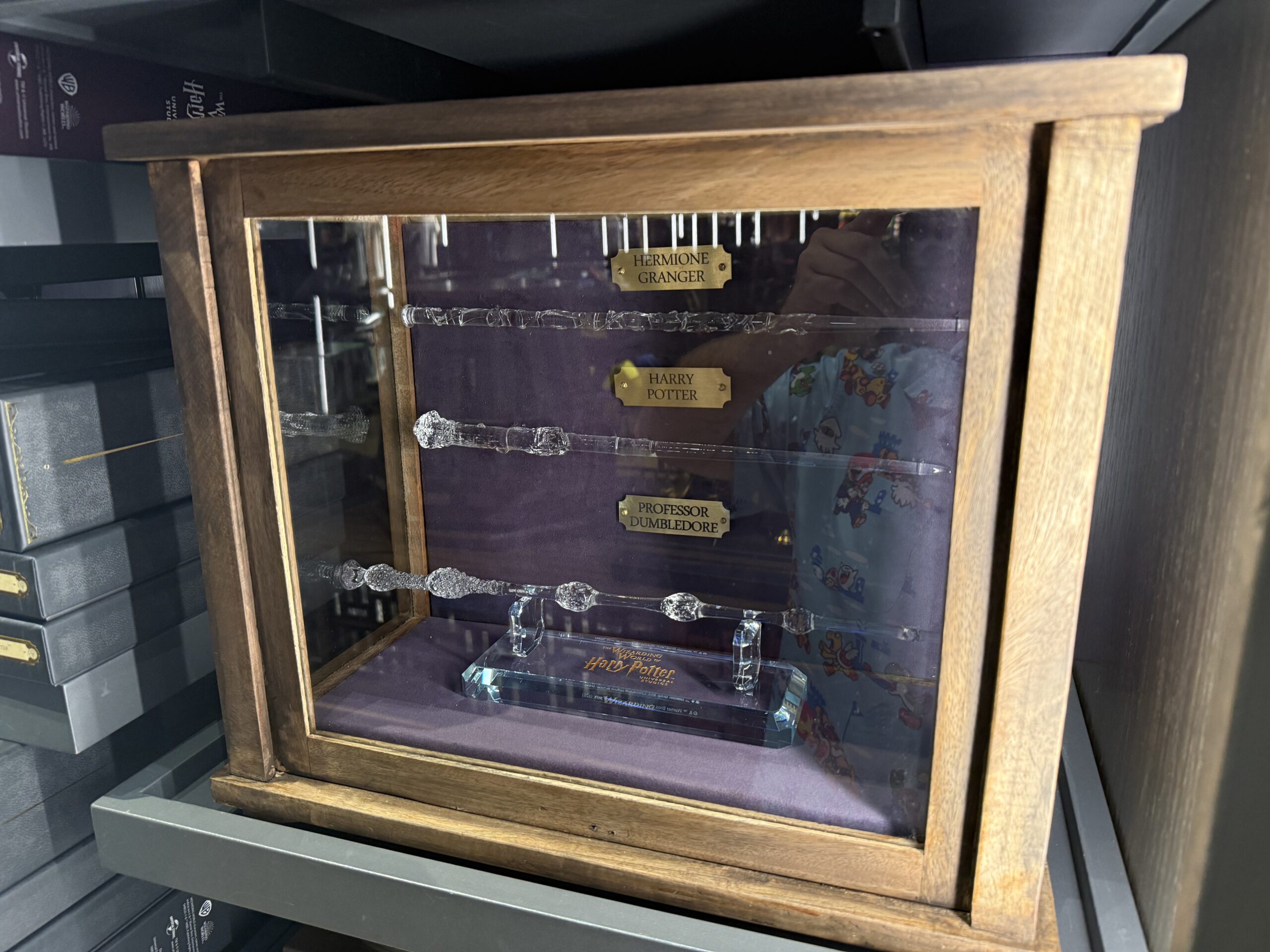 The glass wands are transparent replicas of Hermione Granger's, Harry Potter's, and Professor Dumbledore's wands.