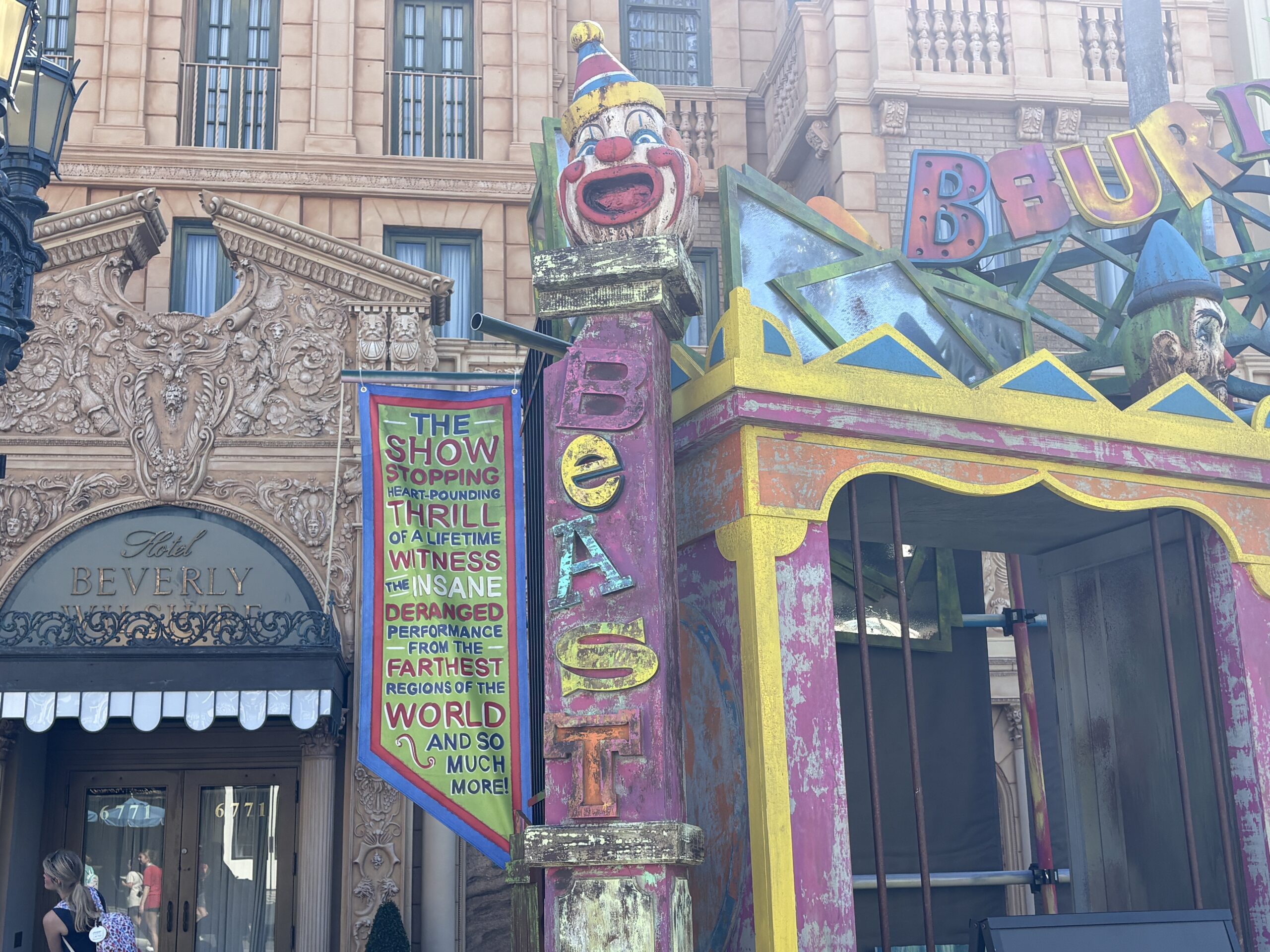 The other clown head is smiling atop a column with