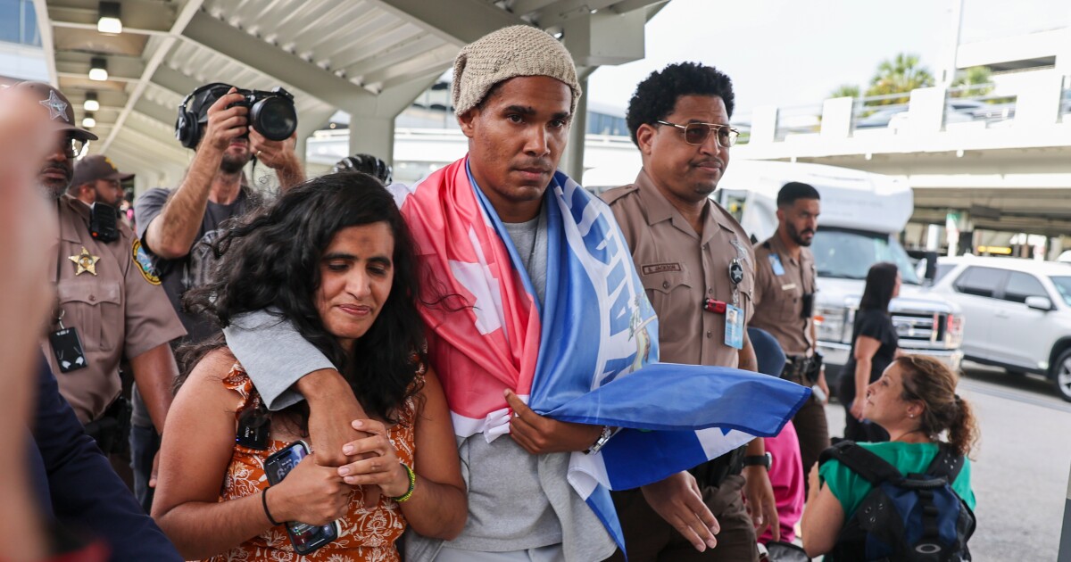 Cuban artist and dissident exiled from country after 5 years in prison arrives in Miami