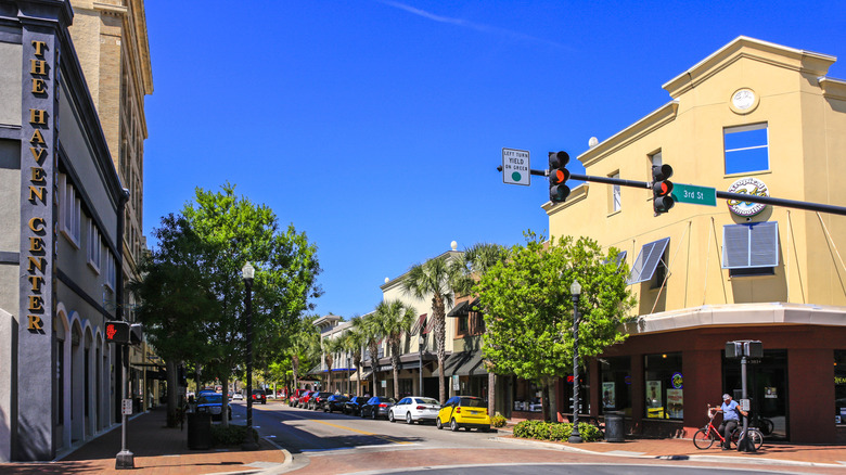 Tree-lined streets and colorful corner buildings under blue skies in Winter Haven's historic district in Florida