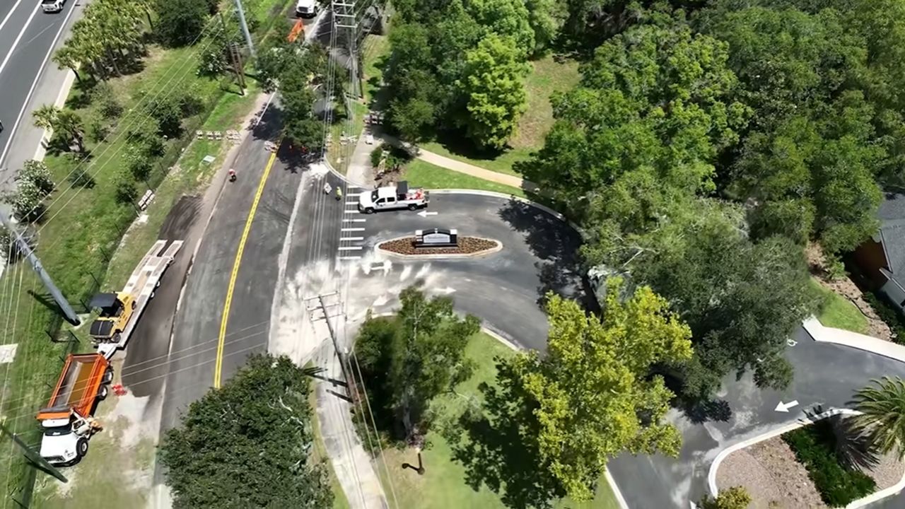 Orange County Public Works crews worked Thursday to put the finishing touches on the repair of Wymore Road after a sinkhole opened on May 15. (Spectrum News/Elmancie Kelley)
