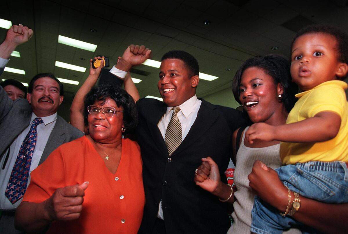 From the archives: U.S. Representative Carrie P. Meek and son Kendrick Meek  celebrate on election night with his wife Leslie Meek and one-year-old son Kendrick Meek Jr., on Sept. 1, 1998.
