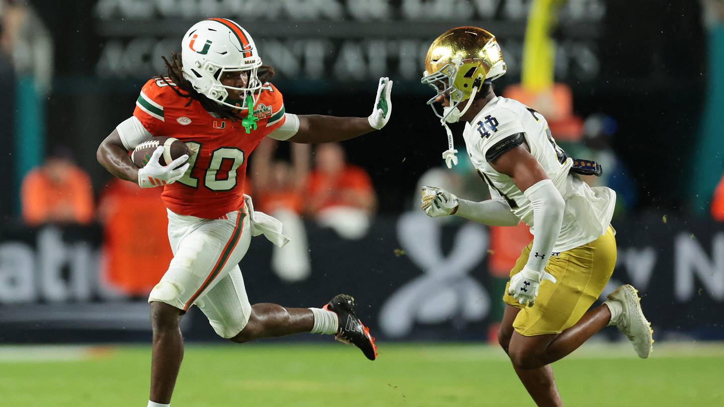 Aug 31, 2025; Miami Gardens, Florida, USA; Miami Hurricanes wide receive Malachi Toney (10) runs with the football against Notre Dame Fighting Irish cornerback Karson Hobbs (21) during the first half at Hard Rock Stadium. Mandatory Credit: Sam Navarro-Imagn Images
