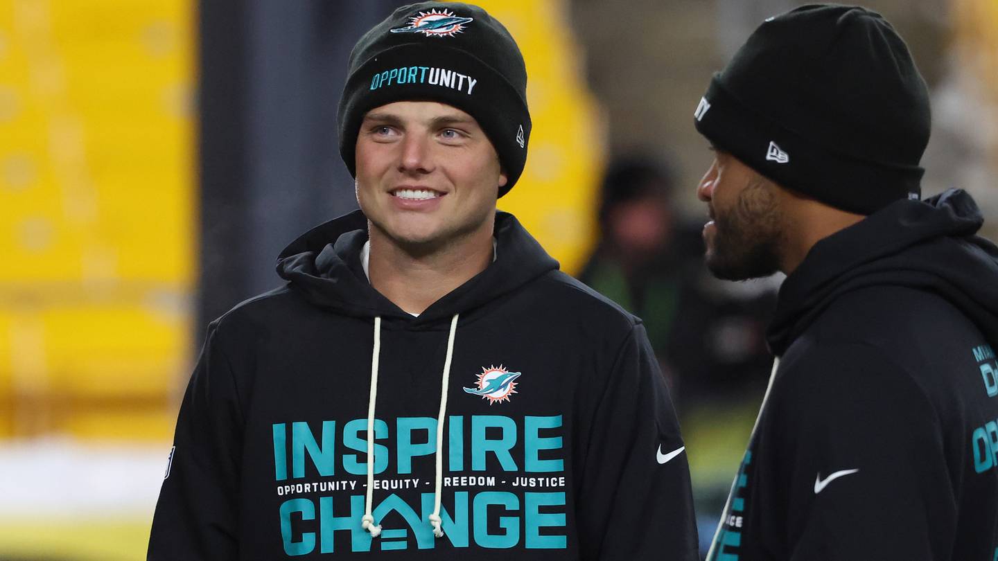 Dec 15, 2025; Pittsburgh, Pennsylvania, USA;  Miami Dolphins quarterbacks Zach Wilson (0), left, and Tua Tagovailoa (1), right, talk on the field before the game against the Pittsburgh Steelers at Acrisure Stadium.