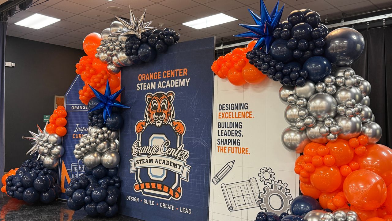 A new sign, balloons and the tiger mascot greet students in the cafeteria at the new Orange Center STEAM Academy. (Spectrum News/Keith Landry)