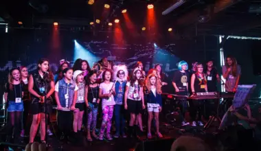Photo of a group of young girls posing by a stage in Miami.