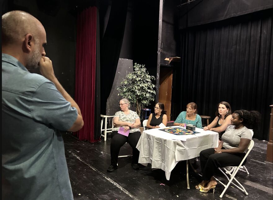 Director Michael Hebler works with 'Odd Couple' cast.