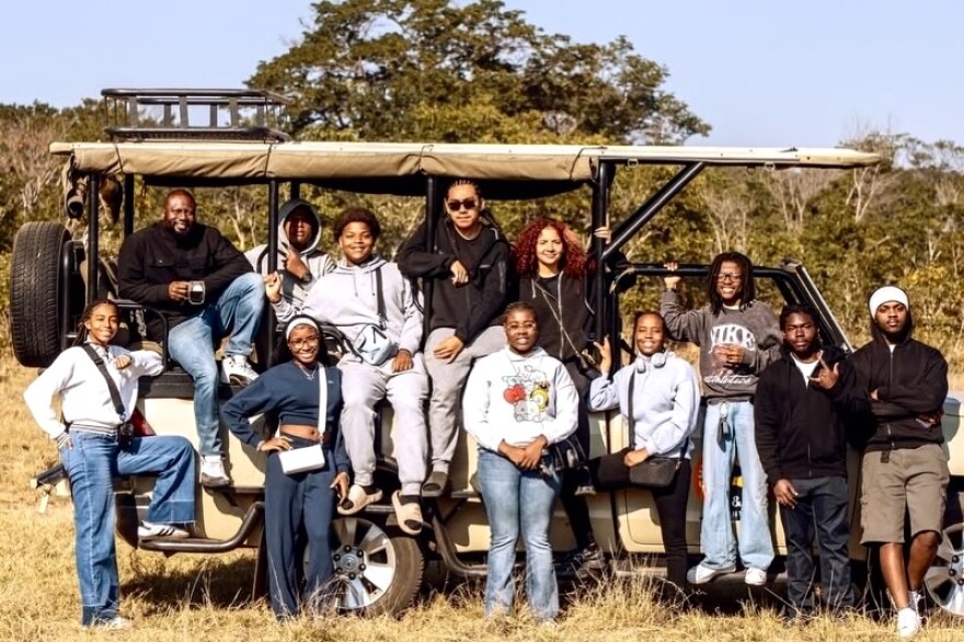 Edwin Sheppard sits alongside Miami Central students on a safari.