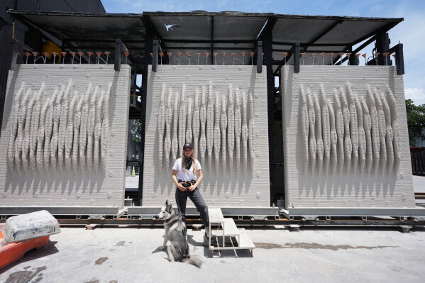 Anya Freeman, CEO and co-founder of KIND Designs, poses for a photograph with 3D-printed living seawalls Tuesday, May 12, 2026, in Miami. (AP Photo/Lynne Sladky)