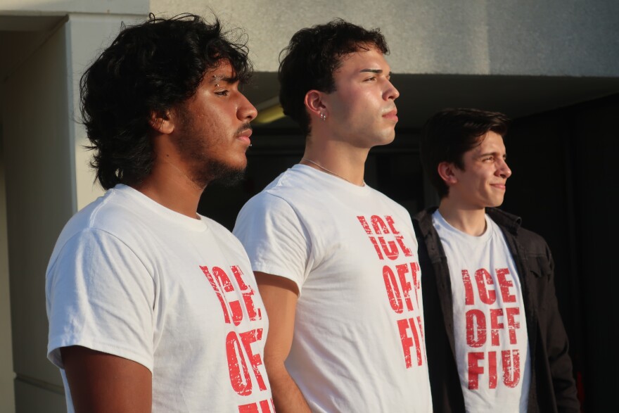 Three men look into the distance with shirts that read "ICE OFF FIU"