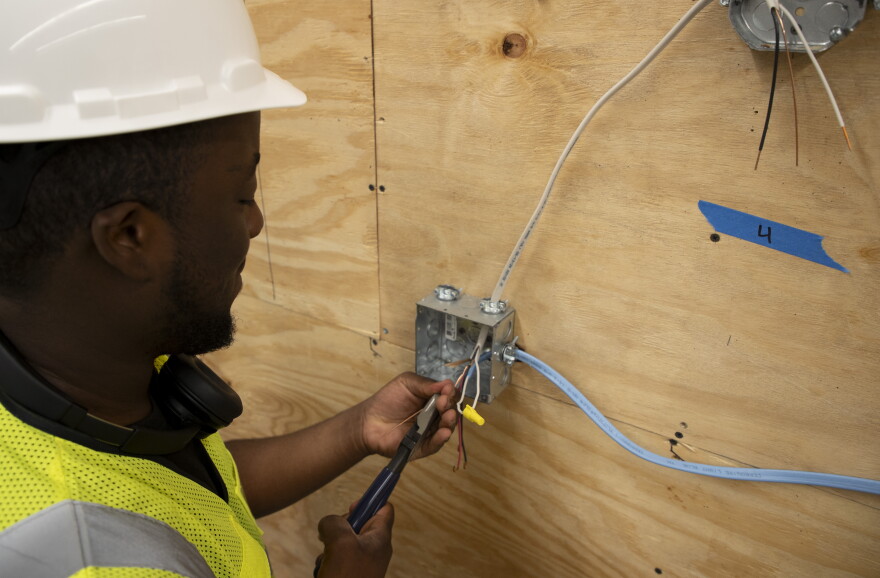 Clarens Joseph wires a light switch in the electrical laboratory on Friday, Aug. 28, 2026, at the Heights Career Tech Institute in Fort Myers.