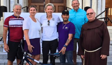 From left, Tim Eves, Catholic Charities of the Diocese of St. Petersburg executive director Maggie Rogers, Tampa mayor Jane Castor, Tom Henry and Br. Michael Jones, OFM. "It's easy to overlook how vital basic transportation is until you see someone's life open up because they now have a reliable way to get to work, school, or medical appointments," Br. Mike said. "It has shown me that small, deliberate efforts, multiplied over time, create profound community transformation. (Photo courtesy of Sacred Heart Parish)