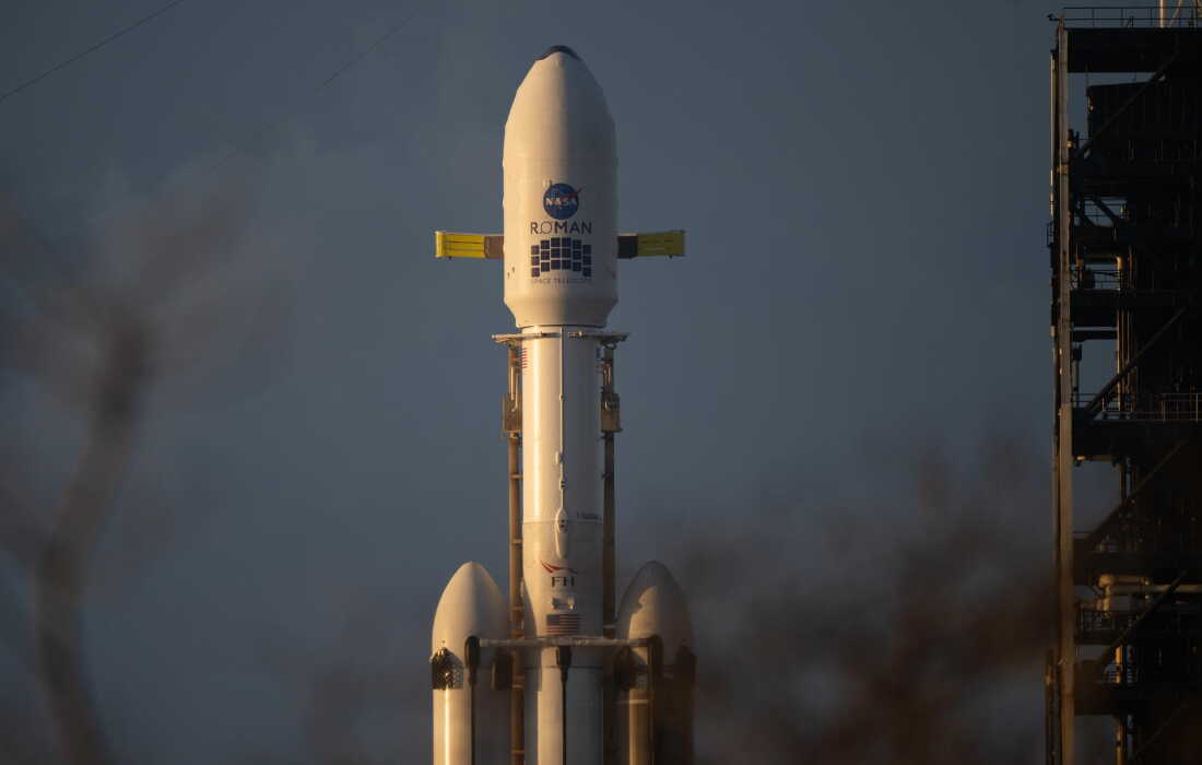 NASA’s Nancy Grace Roman Space Telescope, perched atop a SpaceX Falcon Heavy rocket, is seen at sunrise at Kennedy Space Center in Florida.