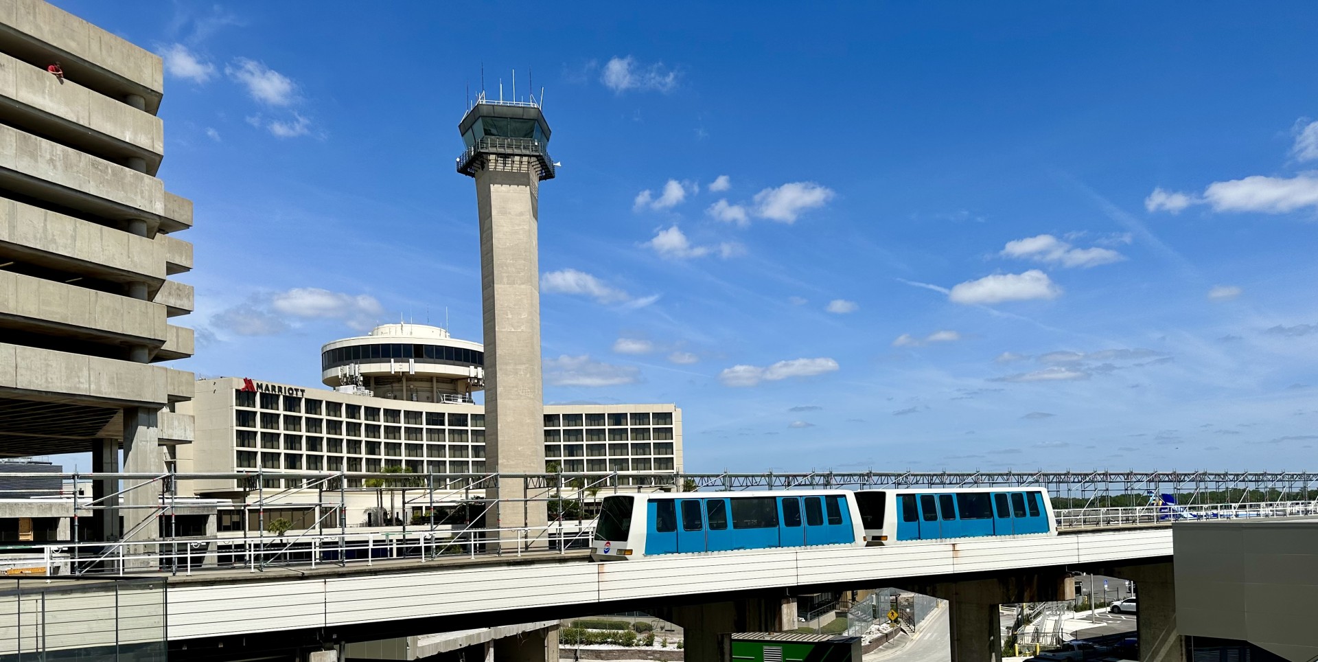 Tampa International Airport’s existing air traffic control tower rises behind an Airside shuttle and the Tampa Airport Marriott.