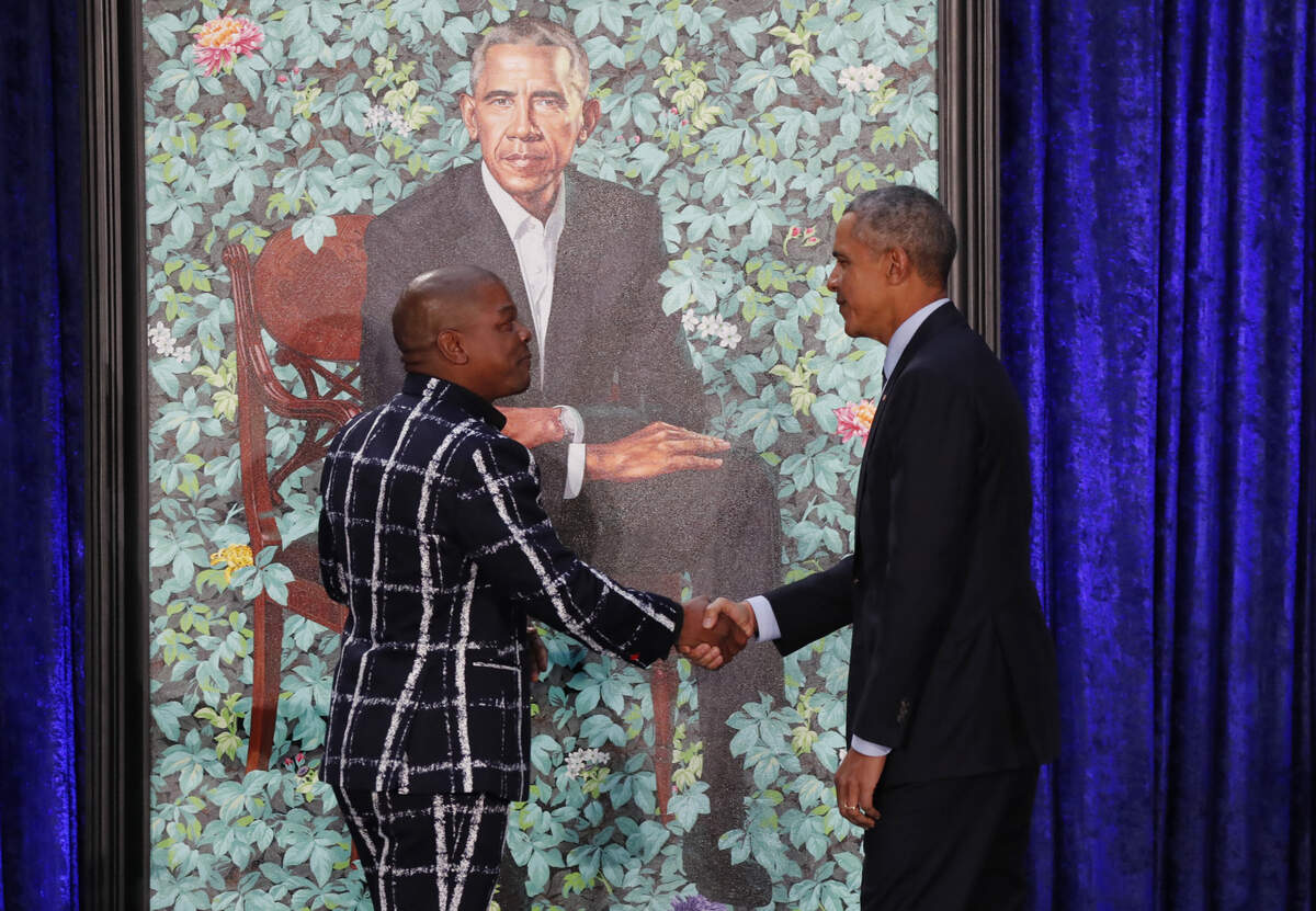 Former U.S. President Barack Obama greets artist Kehinde Wiley during the unveiling of his portrait at the Smithsonian’s National Portrait Gallery in Washington, U.S., February 12, 2018. REUTERS/Jim Bourg
