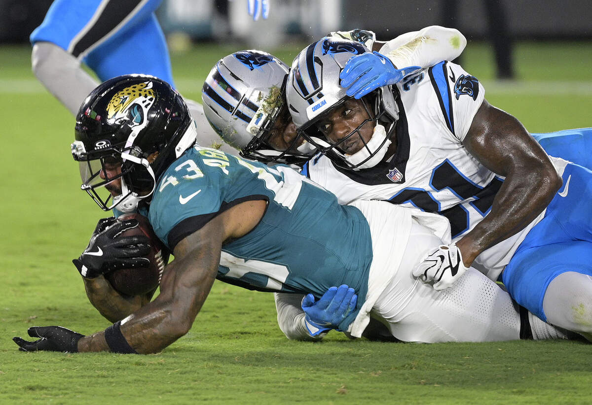 Jacksonville Jaguars running back Ameer Abdullah (43) is tackled by Carolina Panthers cornerback Corey Thornton (31) during the first half of the preseason game at EverBank Stadium in Jacksonville, Fla., on Friday, Aug. 21, 2026.