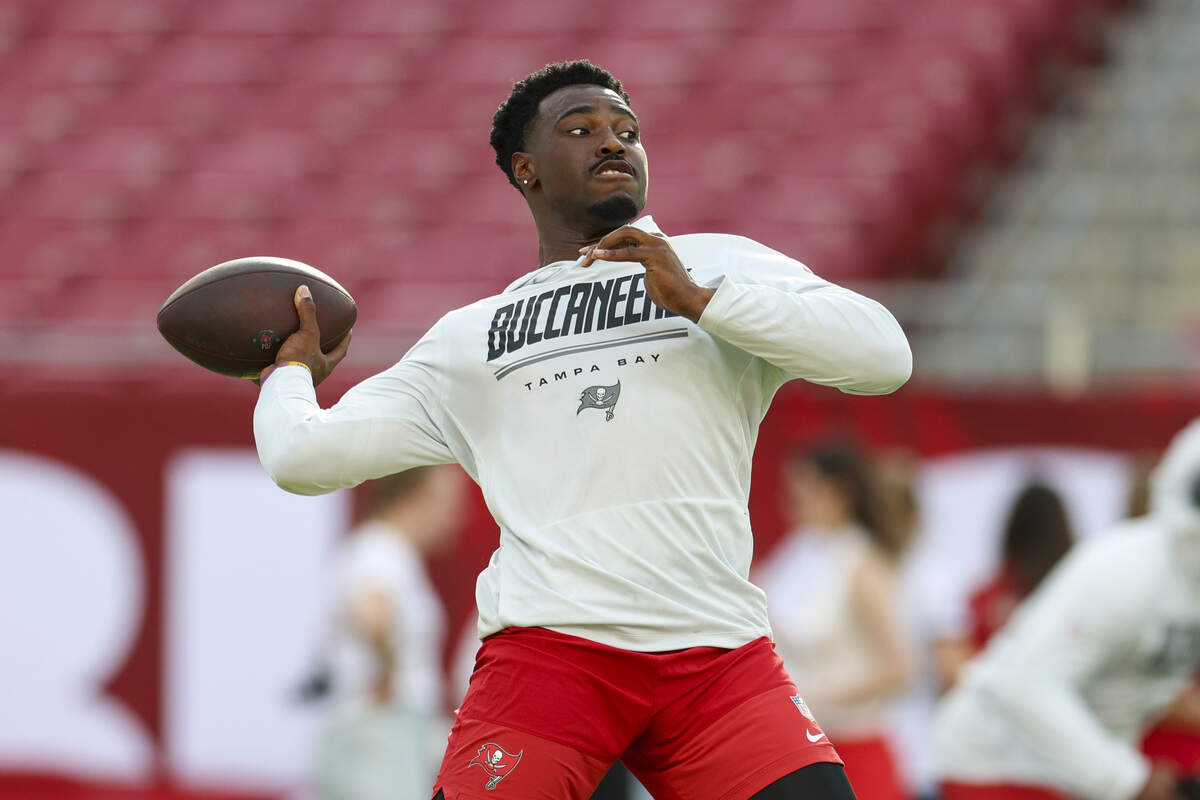 Former Kansas Jayhawks quarterback, now a Buccaneers QB, Jalon Daniels warms up before a preseason NFL game against the Kansas City Chiefs at Raymond James Stadium in Tampa.