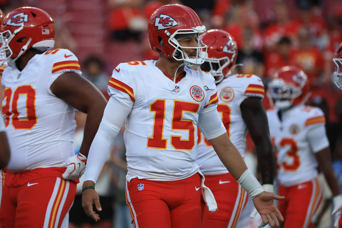 Kansas City Chiefs quarterback Patrick Mahomes shakes hands with teammates as they come off the field before a preseason NFL game against the Buccaneers at Raymond James Stadium in Tampa.