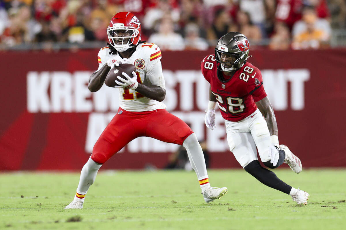 Kansas City Chiefs wide receiver Jalen Royals (11) catches a pass defended by Tampa Bay Buccaneers cornerback Damarion Williams (28) during a preseason NFL game at Raymond James Stadium in Tampa on Saturday, Aug. 22, 2026.
