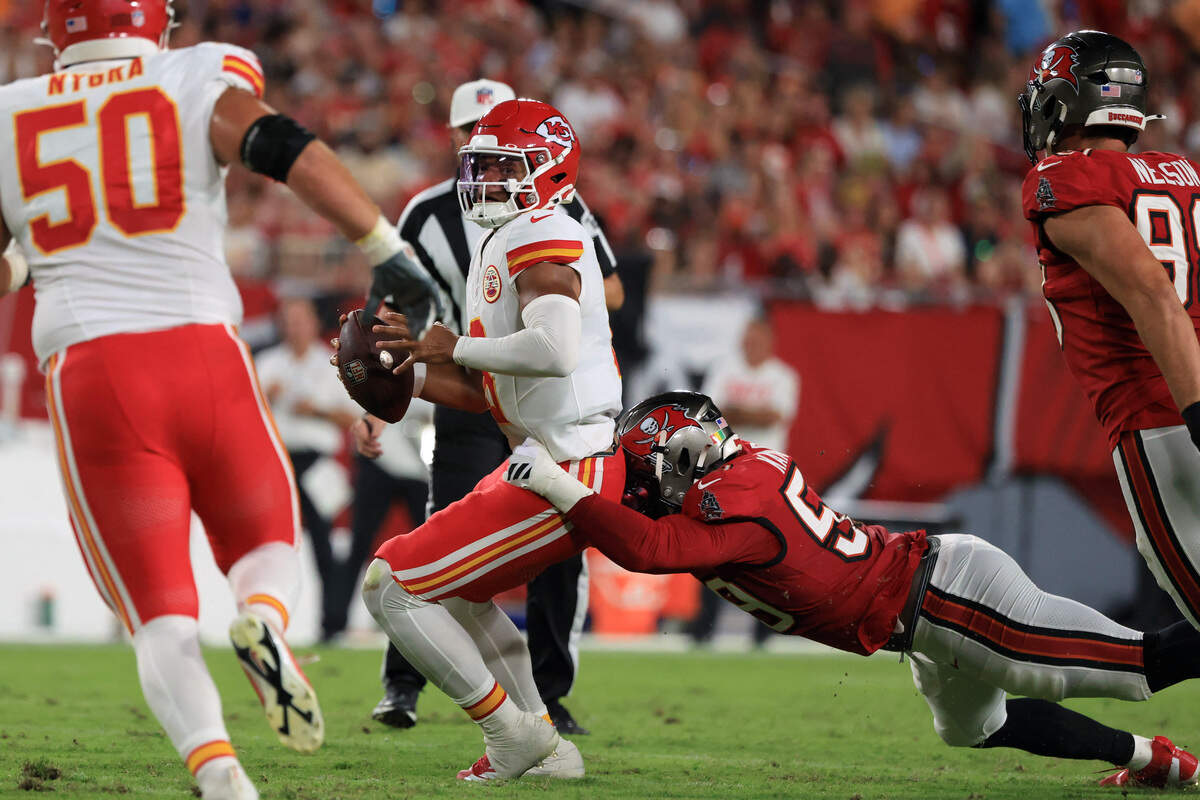 Tampa Bay Buccaneers linebackers Mohamed Kamara (59) and Anthony Nelson (98) sack Kansas City Chiefs quarterback Justin Fields (6) during a preseason NFL game at Raymond James Stadium in Tampa on Saturday, Aug. 22, 2026.