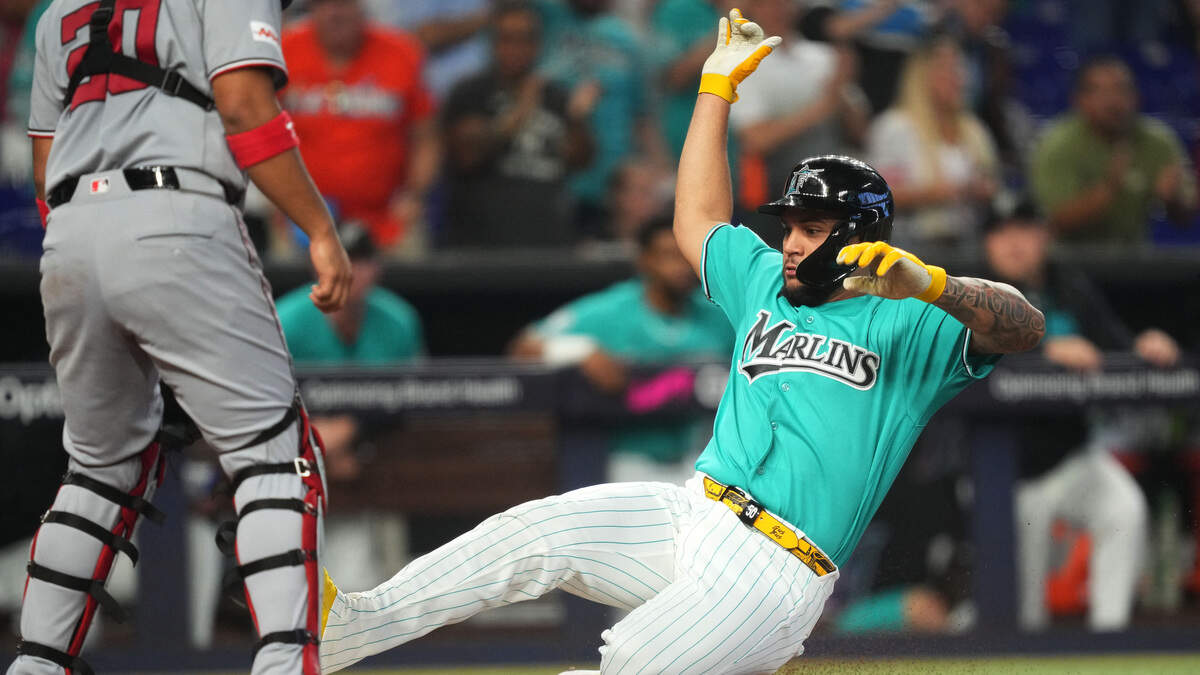 Aug 23, 2026; Miami, Florida, USA; Miami Marlins' Agustin Ramirez (50) slides in safe at home plate as Washington Nationals catcher Keibert Ruiz (20) looks on in the first inning at loanDepot Park. Mandatory Credit: Jim Rassol-Imagn Images Aug 23, 2026; Miami, Florida, USA; Miami Marlins' Agustin Ramirez (50) slides in safe at home plate as Washington Nationals catcher Keibert Ruiz (20) looks on in the first inning at loanDepot Park. Mandatory Credit: Jim Rassol-Imagn Images