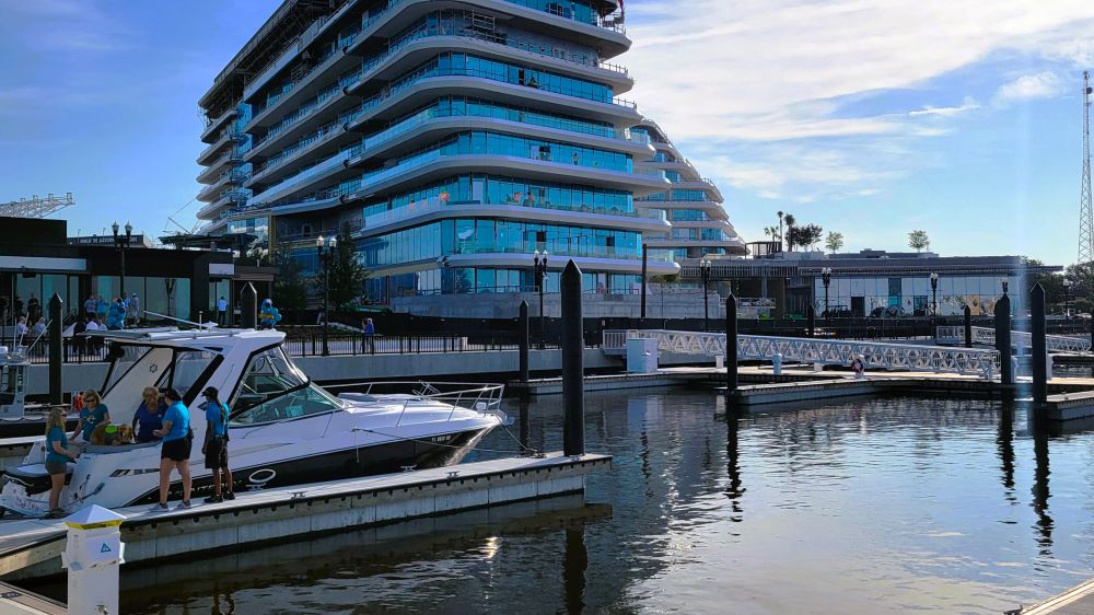 A boat floats at the new Met Park Marina on Wednesday, Aug. 12, 2026, with the Four Seasons Hotel and Residences under construction in the background.