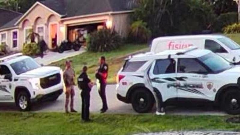 Port St. Lucie police officers outside a residence in the 900 block of Southwest Jaslo Avenue on Thursday, Aug. 20, 2026, during the execution of a search warrant. (Photo obtained by CBS12 News from a neighbor)