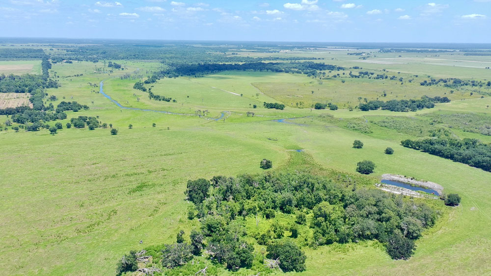 An aerial view of pasture and wetlands